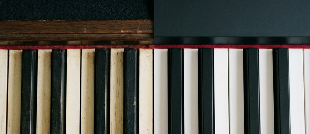 Close-up comparison of acoustic piano keys and digital piano keys