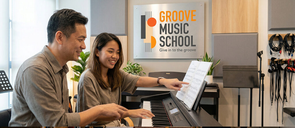 Piano teacher guiding a student during a personalised piano lesson at Groove Music School